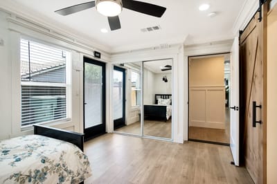 Bright interior of a resident room with bed and closet