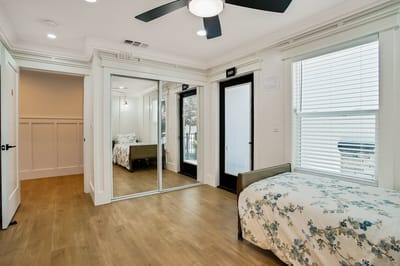 A private resident room with a bed and mirror