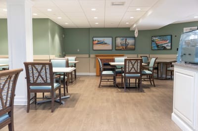 Bright dining area with wooden tables and chairs