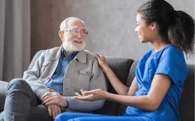 A caregiver conversing with an elderly resident