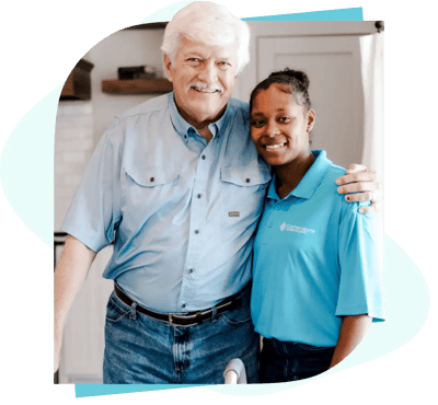 A senior resident posing with a caregiver