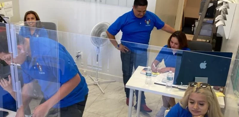 Staff members interacting in an office space.