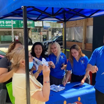 Staff engaging with community members at an outdoor event.
