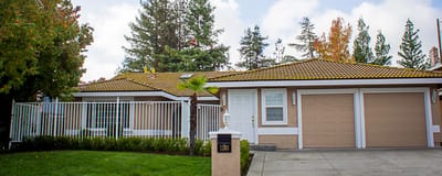 Exterior view of a residential facility with landscaping.
