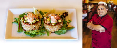 Chef presenting a plated meal in the dining area.