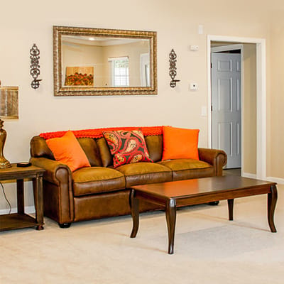 Cozy living room with a brown sofa and colorful pillows.