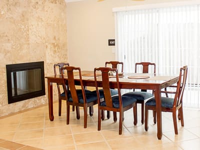 Dining area with wooden table and chairs.