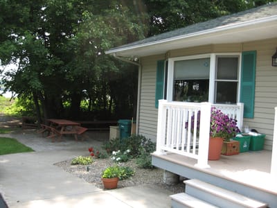 Exterior view of a porch with flowers and seating