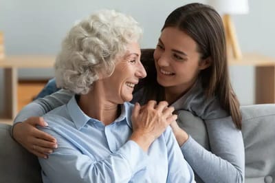 Senior woman and caregiver sharing a joyful moment