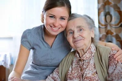 Smiling caregiver with elderly resident