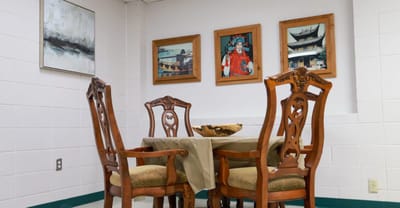 A dining area with a table and decorated walls