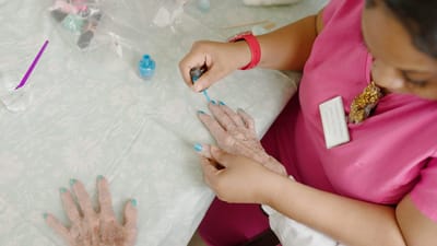 Resident receiving a manicure from staff.