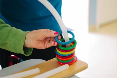 Hand of a resident playing with colorful rings
