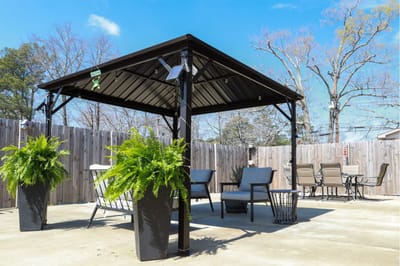 Outdoor seating area with gazebo and plants