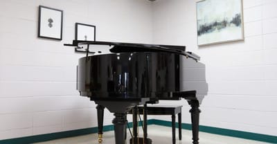 A black grand piano in a well-lit room