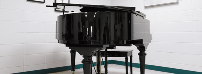 Black grand piano in a facility's interior.