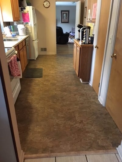 Narrow hallway leading to a kitchen area