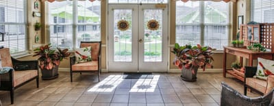 Bright sunroom with plants and seating area