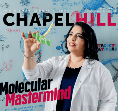 A woman in a lab coat holding a molecular model