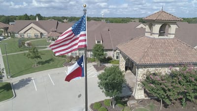Aerial view of Belterra Health & Rehabilitation building with flags