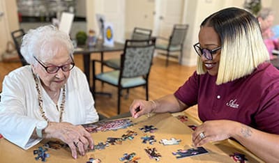 Residents working on a puzzle in a common area