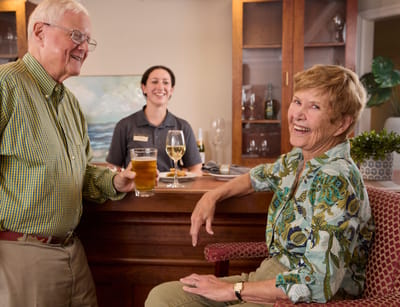 Brandywine The Savoy, assisted living in Queens, NY — Seniors enjoying drinks at a bar with staff