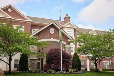 Brandywine The Savoy, assisted living in Queens, NY — Entrance of a senior living facility with landscaped grounds