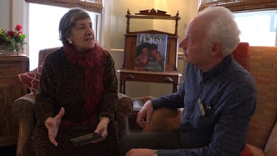 Two residents engaged in conversation in a cozy setting