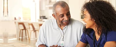 Caregiver and resident enjoying time together in a bright room
