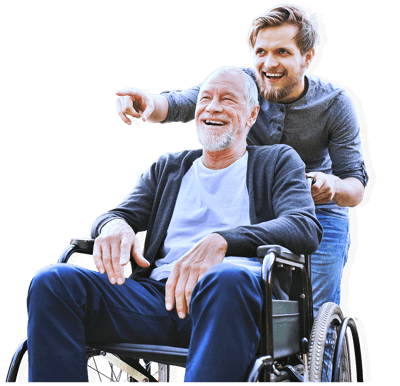 A smiling elderly man in a wheelchair with a caregiver