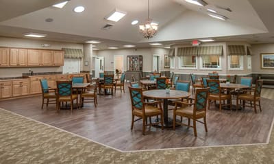 Well-lit dining area with tables and chairs