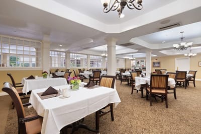 Dining room set with tables and flowers