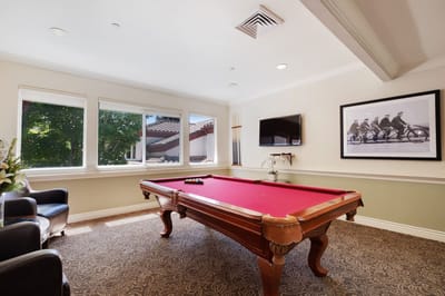 Interior game room with a pool table and seating