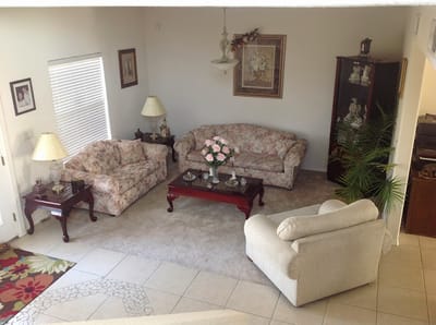 Interior common area with floral couches and decor