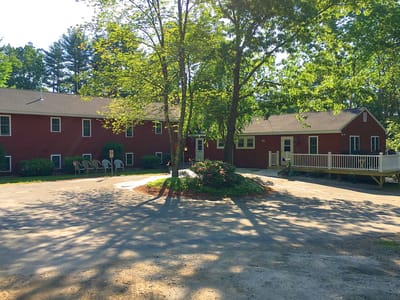 Exterior view of assisted living facility surrounded by trees