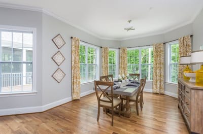 Bright dining area with large windows and stylish decor