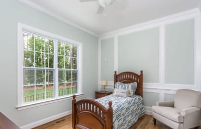 Cozy resident room with a single bed and chair