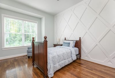 Cozy bedroom with a wooden bed and patterned bedding