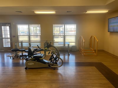 Rehabilitation gym with exercise equipment and therapy stairs