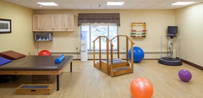 Rehabilitation activity room with exercise equipment and therapy balls