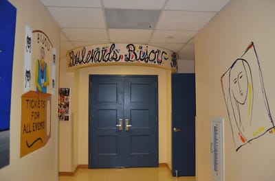 Hallway with colorful artwork and signage