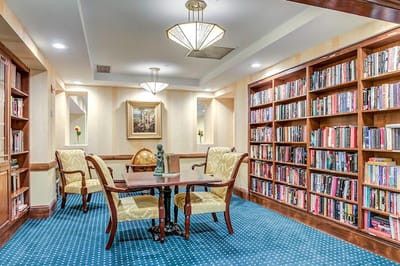 A cozy library area with bookshelves and seating