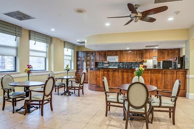 Bright dining area with tables and a kitchenette