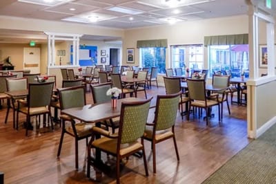 Bright dining area with tables and chairs set up