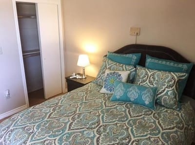 Cozy bedroom with teal accents and a lamp