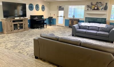 Interior common area with seating and a television