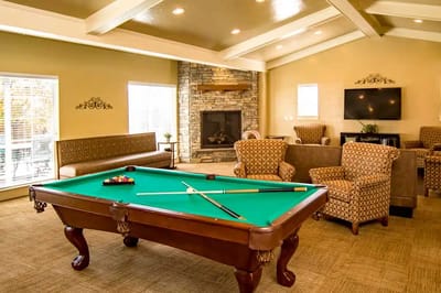 Interior game room with billiards table and seating