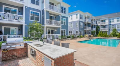 Outdoor view of the facility with a pool and seating area