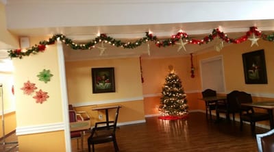 Decorated common area with a Christmas tree and holiday decor