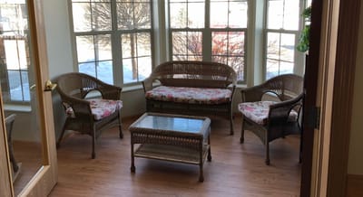 Cozy sitting area with wicker furniture and floral cushions